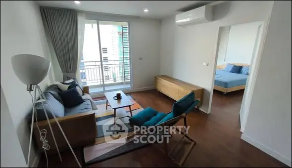 Modern living room with stylish furniture and balcony view in a contemporary apartment.