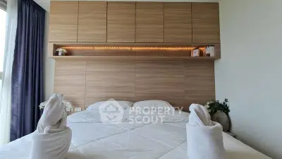 Modern bedroom with stylish wooden paneling and cozy bedding