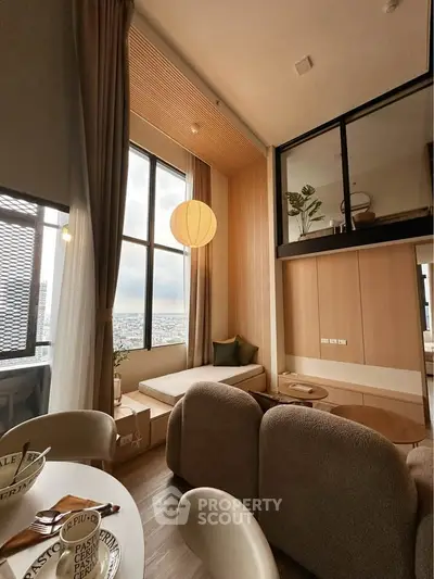 Stylish modern living room with loft design and large windows offering city views.