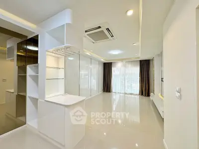 Spacious modern living room with sleek design and large windows for natural light.