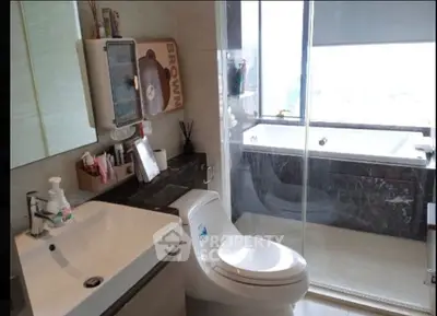 Modern bathroom with sleek fixtures and glass shower enclosure
