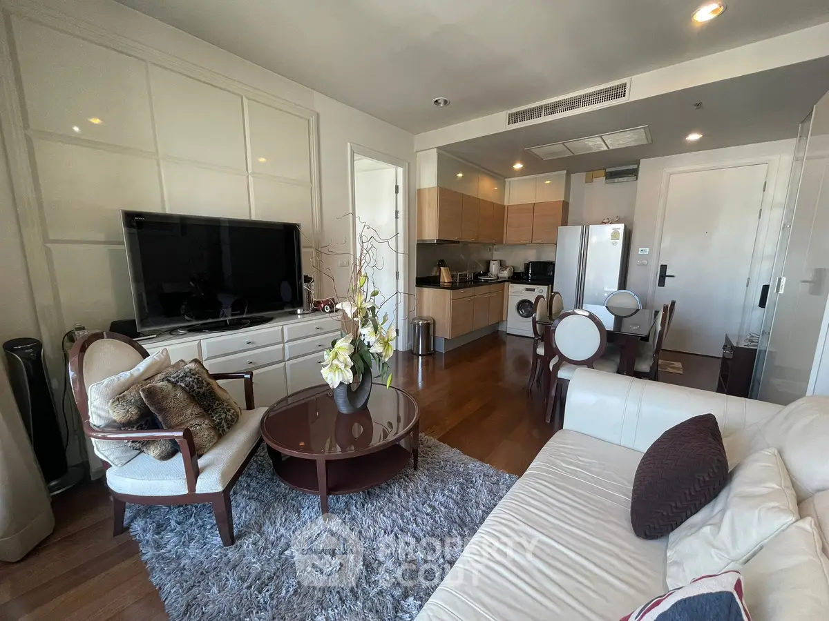 Stylish living room with modern furniture and open kitchen layout in a cozy apartment.