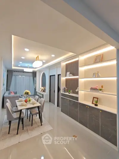 Modern open-plan living and dining area with elegant lighting and stylish decor