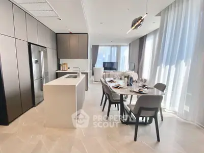 Luxurious open-plan kitchen and dining area with modern design and ample natural light.
