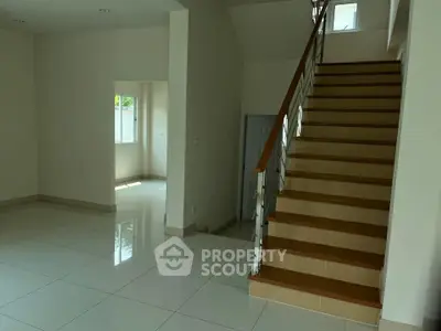 Spacious modern interior with elegant staircase and natural light