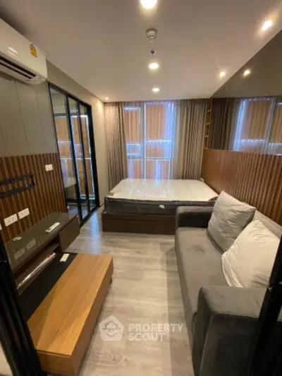 Modern studio apartment with cozy bed and stylish decor