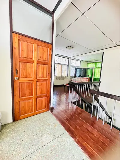 Spacious interior with wooden flooring and natural light, ideal for cozy living.