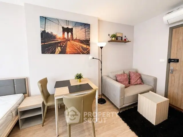 Cozy living room with modern decor and dining area in a stylish apartment.