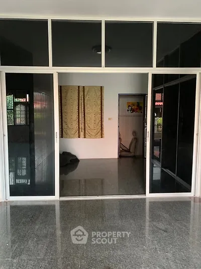 Spacious interior with glossy floors and sliding glass doors, ideal for modern living.