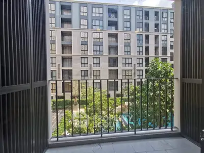 Modern apartment balcony with pool and garden view