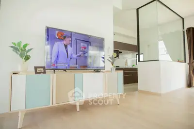 Modern living room with stylish TV stand and open kitchen layout