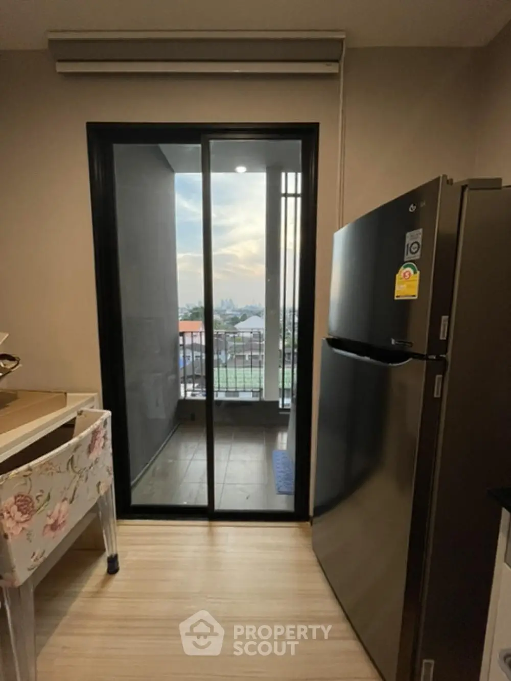 Modern kitchen with balcony view and sleek refrigerator