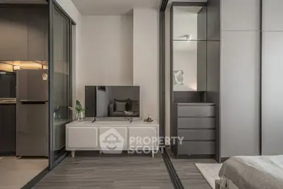 Modern apartment interior with sleek kitchen and cozy living area featuring stylish decor.