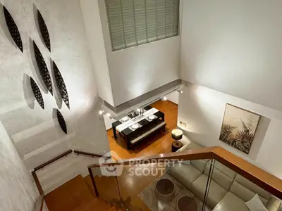 Luxurious modern living room with elegant staircase and dining area, perfect for stylish urban living.