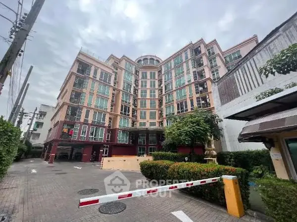 Stunning multi-story residential building with modern architecture and lush greenery in urban setting.