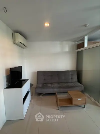 Modern living room with sleek furniture and air conditioning, perfect for relaxation and entertainment.