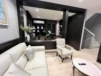 Elegant living room with modern decor and cozy seating area, perfect for relaxation and entertainment.