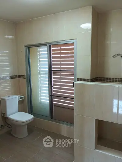 Spacious bathroom with modern fixtures and natural light