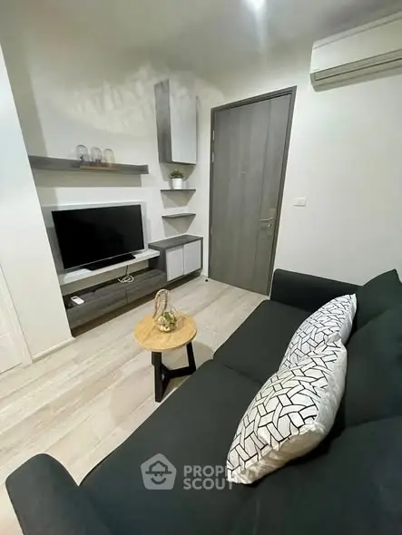 Modern living room with sleek furniture and wall-mounted TV, perfect for cozy relaxation.