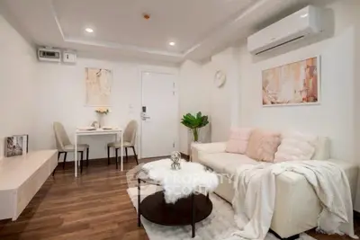 Cozy living room with modern decor and air conditioning, perfect for relaxation.