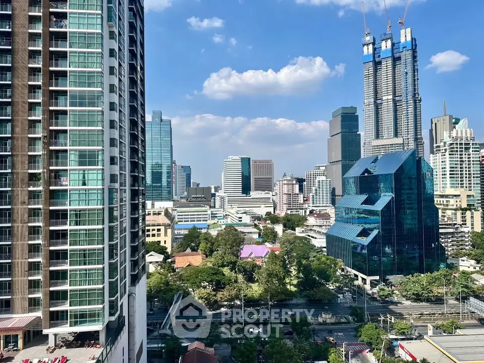 Stunning cityscape view from high-rise apartment balcony in vibrant urban area.