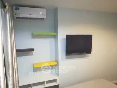 Modern bedroom with wall-mounted TV and colorful shelves, featuring sleek air conditioning unit.