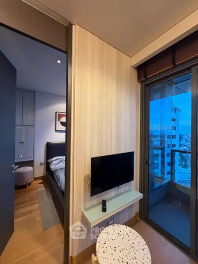 Modern bedroom with balcony view in high-rise apartment