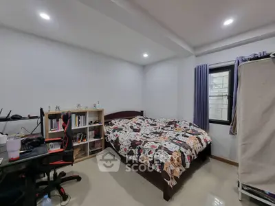 Cozy bedroom with modern decor and ample natural light