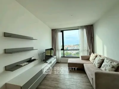 Modern living room with sleek design and large window offering scenic view