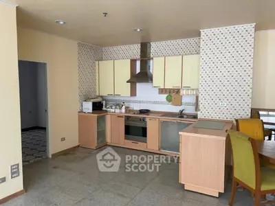 Spacious kitchen with modern appliances and open layout in a cozy apartment.