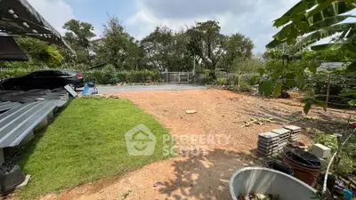 Spacious outdoor garden area with potential for landscaping and development, featuring lush greenery and open space.