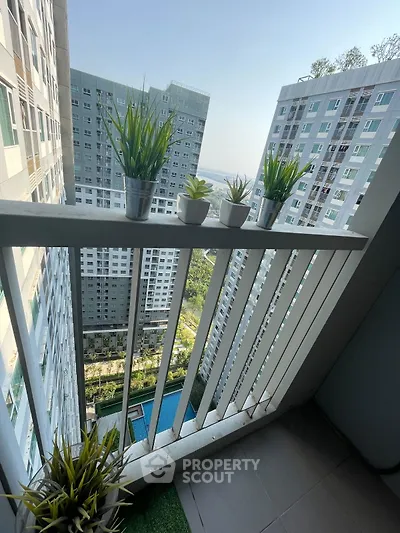 Stunning high-rise balcony view with lush greenery and modern architecture.