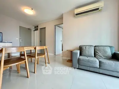 Spacious living room with modern furniture and air conditioning in a stylish apartment.