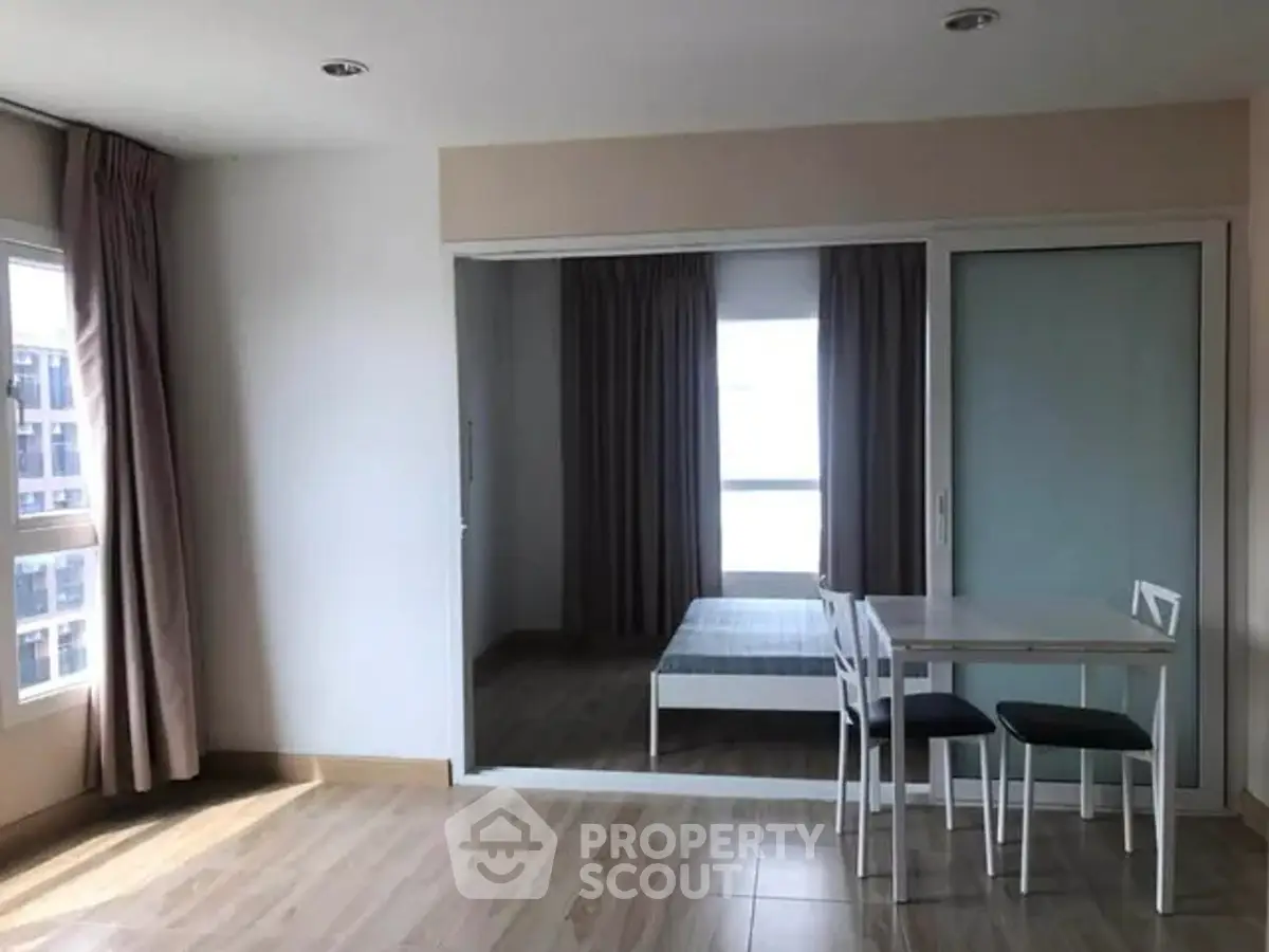 Modern apartment interior with minimalist dining area and bedroom view