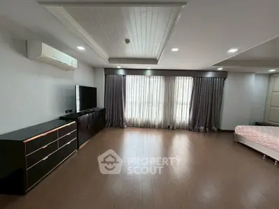 Spacious modern living room with sleek furniture and large windows