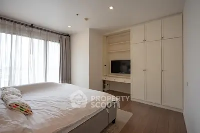 Spacious bedroom with built-in wardrobe and natural light