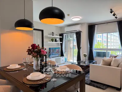 Modern living room with elegant dining area and large windows offering natural light.