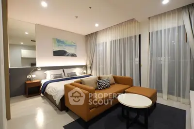 Modern bedroom with cozy seating area and stylish decor