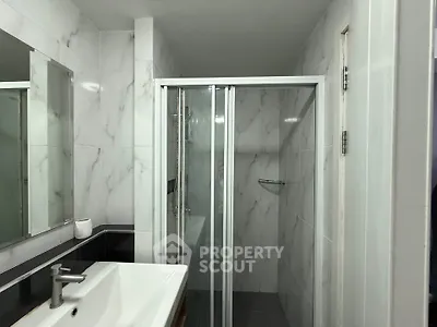 Modern bathroom with sleek shower and elegant marble tiles