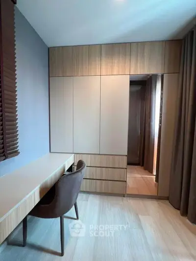 Modern study room with sleek built-in storage and elegant desk chair setup.
