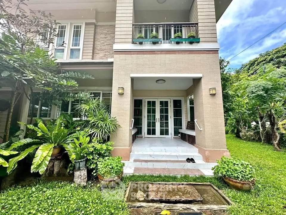 Charming two-story home with lush garden and inviting entrance