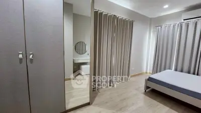 Spacious bedroom with modern decor and ample natural light