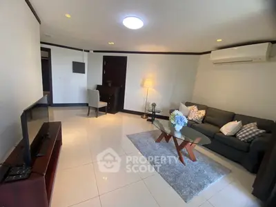 Spacious living room with modern furniture and air conditioning in a stylish apartment.