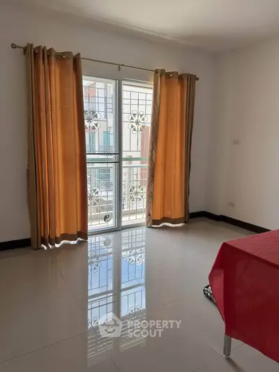 Bright room with large window and elegant curtains, perfect for natural light lovers.