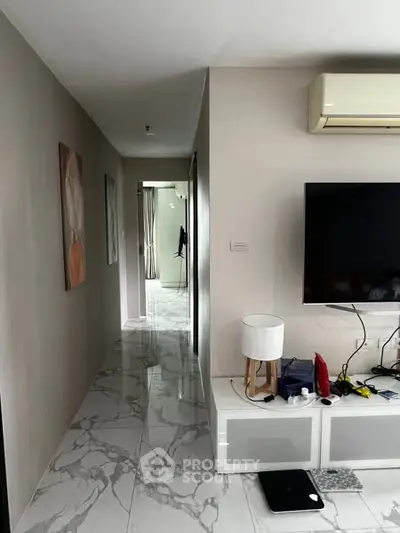 Modern living room with sleek marble flooring and wall-mounted TV