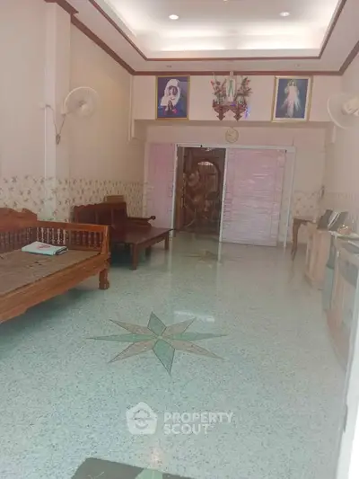 Spacious living room with elegant decor and unique floor design, perfect for family gatherings.