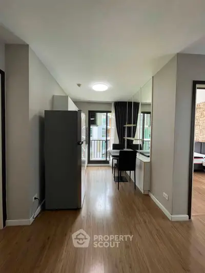Modern apartment interior with wooden flooring and balcony view