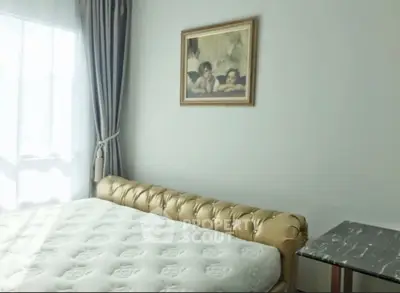 Elegant bedroom with luxurious tufted bed and classic artwork, perfect for serene relaxation.