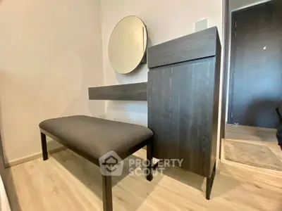 Modern bedroom corner with stylish furniture and round mirror