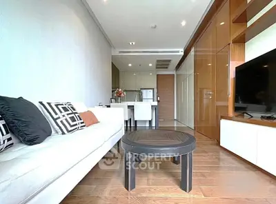 Modern living room with sleek furniture and open layout, featuring a stylish sofa and dining area.